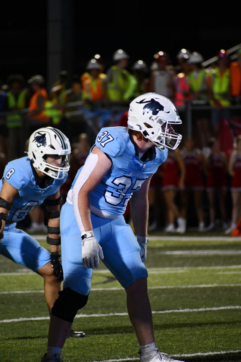 Senior linebackers Wyatt Gardiser and Tate Beam assess the Farmington offensive formation to get a good read on the ball. The Wildcats defeated the non-conference opponent 65-50 on Sept. 6. Despite the score, the game resulted in a forfeiture due to an ineligible player. 